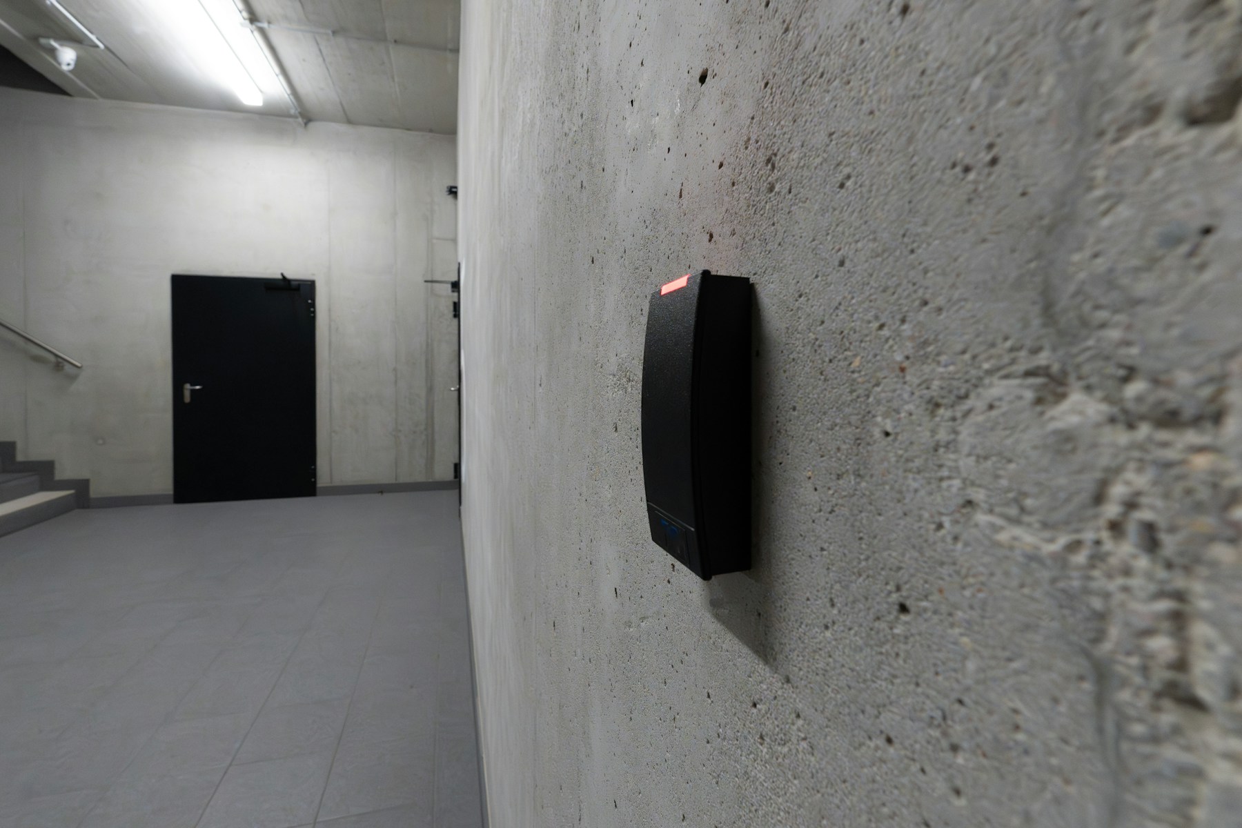 Access control card reader mounted beside a secured entry